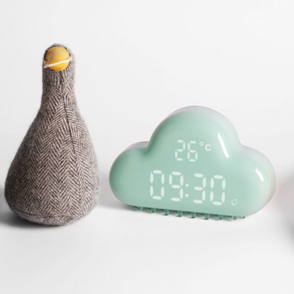 Réveil nuage bleu devant une peluche canard